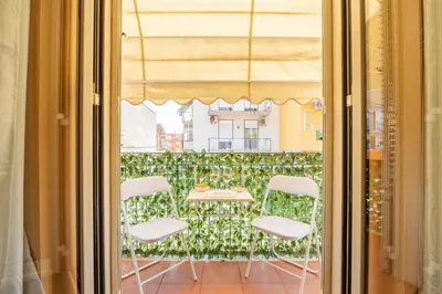 a room with a table and chairs through a window at nonMama - Comfort & charm in Partanna Mondello in Palermo