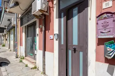 a building with a door on the side of a street at nonMama - Comfort & charm in Partanna Mondello in Palermo