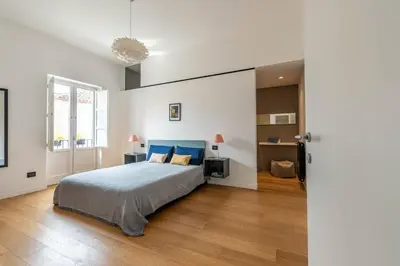 a bedroom with a bed with a blue headboard at Bellini Apartment by Wonderful Italy in Palermo