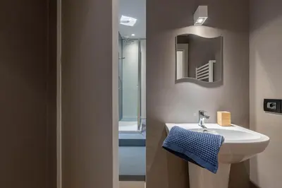 a bathroom with a sink and a mirror at Bellini Apartment by Wonderful Italy in Palermo