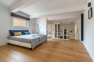 a bedroom with a large bed and a wooden floor at Bellini Apartment by Wonderful Italy in Palermo