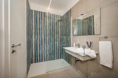 a bathroom with a sink and a shower at Villa Maria con piscina e vista mare 12 posti letto in Castellammare del Golfo