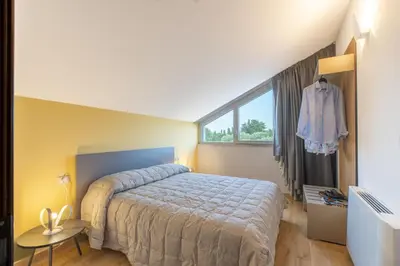 a bedroom with a large bed and a window at Villa Aversa by PosarelliVillas in Castellammare del Golfo