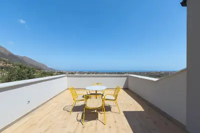 a balcony with a table and chairs on it at Villa Aversa by PosarelliVillas in Castellammare del Golfo