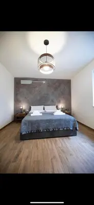 a bedroom with a large bed and a chandelier at Duomo View Apartment in Monreale