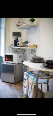 a kitchen with a counter and a table and a microwave at Duomo View Apartment in Monreale