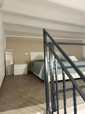 a bedroom with a bed and a staircase at Casa AG in Palermo
