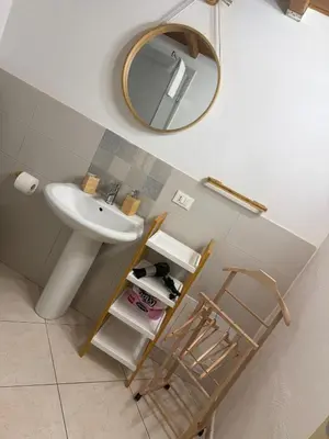 a bathroom with a sink and a mirror at Casa Bastiano in Palermo