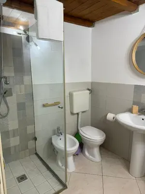 a bathroom with a toilet and a sink at Casa Bastiano in Palermo