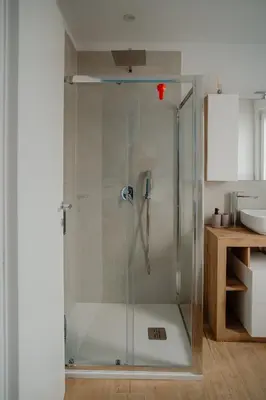a shower with a glass door in a bathroom at Sarina's apartment in Palermo