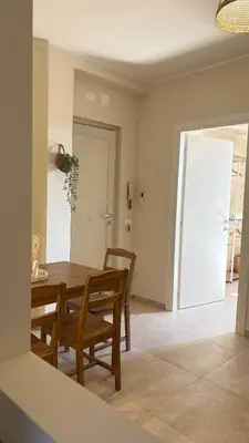 a dining room with a wooden table and chairs at Ciàuru di mari Mondello apartment and terrace in Palermo