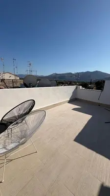 a pair of chairs sitting on top of a roof at Ciàuru di mari Mondello apartment and terrace in Palermo