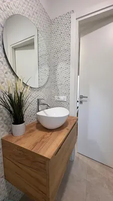 a bathroom with a bowl sink and a mirror at Ciàuru di mari Mondello apartment and terrace in Palermo