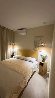a bedroom with a large bed and two night stands at Ciàuru di mari Mondello apartment and terrace in Palermo