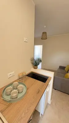 a kitchen with a table with bowls on it at Ciàuru di mari Mondello apartment and terrace in Palermo