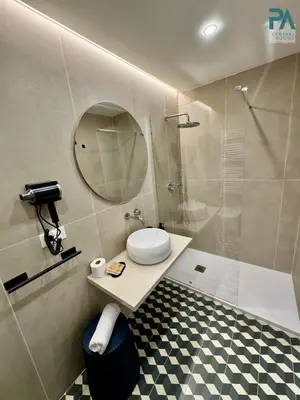 a bathroom with a toilet and a shower with a mirror at Palermo Central Rooms in Palermo