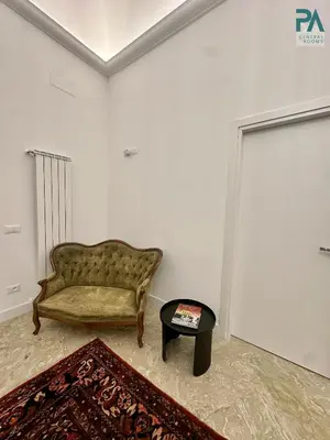 a living room with a couch and a table at Palermo Central Rooms in Palermo