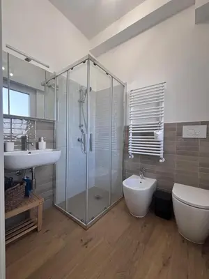 a bathroom with a shower and a toilet and a sink at Casa Mama in Palermo