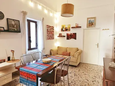 a living room with a table and a couch at La Casa Nei Mondi in Palermo
