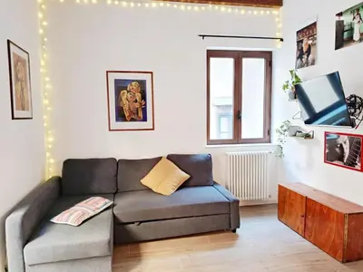 a living room with a couch and a tv at La Casa Nei Mondi in Palermo