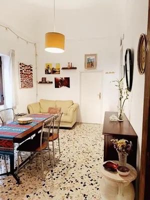 a living room with a table and a couch at La Casa Nei Mondi in Palermo