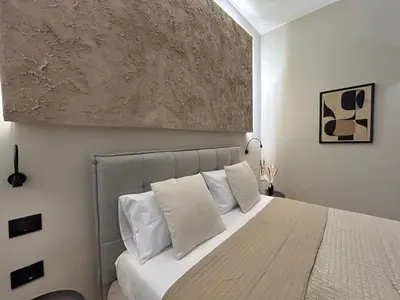 a bedroom with a large bed with white pillows at Vulpi 29 Apartment-Deluxe in Palermo
