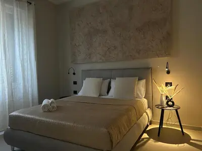 a bedroom with a large bed and a window at Vulpi 29 Apartment-Deluxe in Palermo
