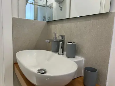 a white sink in a bathroom with a mirror at Vulpi 29 Apartment-Deluxe in Palermo