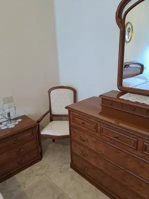 a bedroom with a dresser and a mirror and a chair at ANGELA Rooms in Marineo