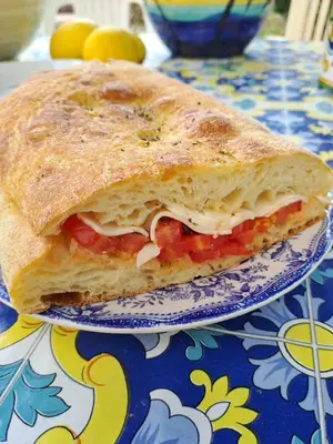 a sandwich on a plate on a table at ANGELA Rooms in Marineo