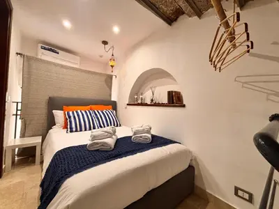 a bedroom with a bed with towels on it at Marie Claire Guest House in Palermo