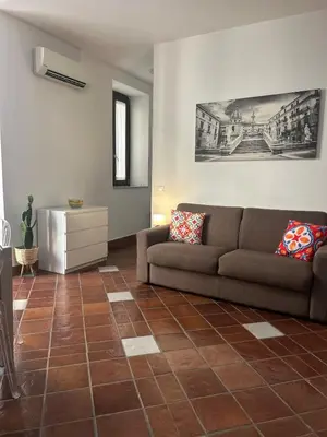 a living room with a couch and a table at Tinchitè - A due passi dal Teatro Massimo in Palermo