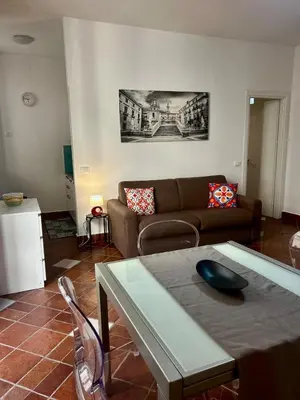 a living room with a couch and a table at Tinchitè - A due passi dal Teatro Massimo in Palermo