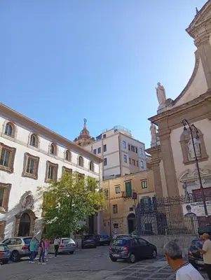 a group of people walking around a city street at Casetta Professa Centro in Palermo