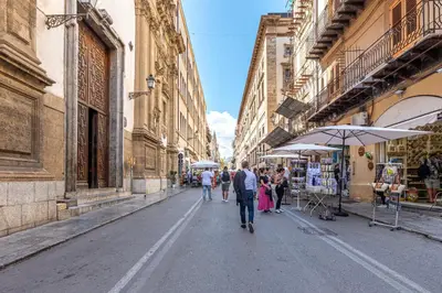 a group of people walking down a street at San Salvatore Apartment by Wonderful Italy in Palermo