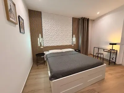 a bedroom with a bed and a table at Dimora Santa Spina in Palermo