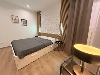 a small bedroom with a bed and a chair at Dimora Santa Spina in Palermo