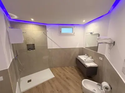 a bathroom with a sink and a shower and a toilet at Dimora Santa Spina in Palermo