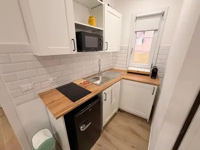 a small kitchen with a sink and a microwave at Dimora Santa Spina in Palermo