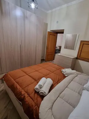 a bedroom with a large bed with towels on it at La Pergola in Palermo