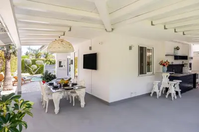 a living room with white walls and a table and chairs at Elegant Villa With Pool Luxury in Carini