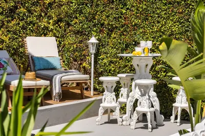 a patio with white furniture and a table and chairs at Elegant Villa With Pool Luxury in Carini