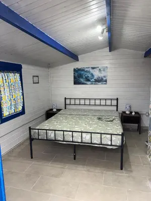 a bunk bed in a room with purple cabinets at Villa Liliana in San Giuseppe Jato