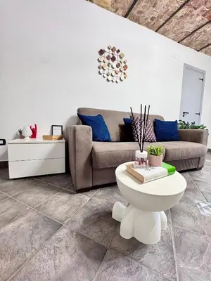 a living room with a couch and a table at Nel Cuore del Capo in Palermo