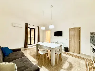 a living room with a white table and a couch at Dimora Sant'Agostino in Palermo