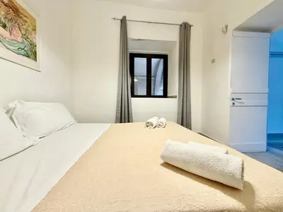 a bedroom with a large white bed with towels on it at Dimora Sant'Agostino in Palermo