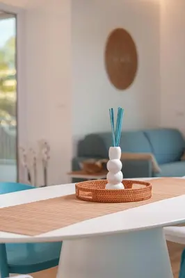 a table with a vase on top of a table at Luxury apartment Villa Vera Mondello - Palermo in Mondello