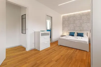 a living room with a blue couch and a table at Luxury apartment Villa Vera Mondello - Palermo in Mondello