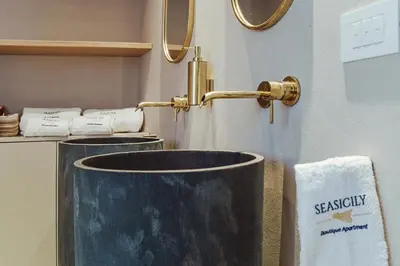 a bathroom with a sink and a towel at Seasicily Boutique Apartment in Palermo