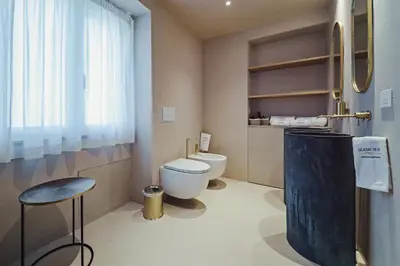 a bathroom with a toilet and a stool at Seasicily Boutique Apartment in Palermo